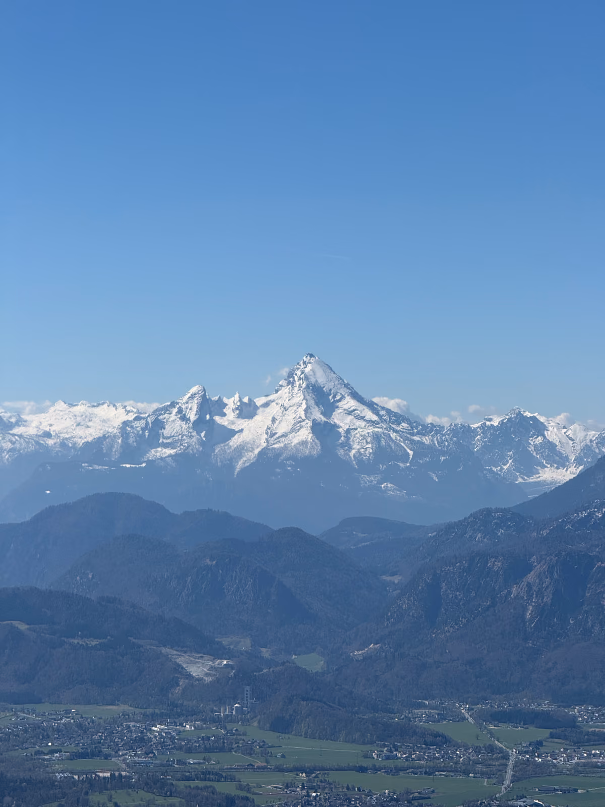 A snow-covered alpine peak rising above the valley